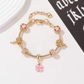 Detail of golden charm bracelet with pink clover pendant and hollow heart beads - Pink Clover Pendant 17cm