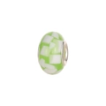 Macro detail of a green and white mosaic glass charm bead with a metal core for DIY bracelets - Green