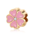 Detail of pink enamel cherry blossom charm with gold plating and center crystal stone - Pink