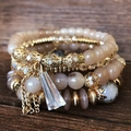 Bohemian multi-layer beaded bracelet with crystal prism pendant on dark wood base - Coffee