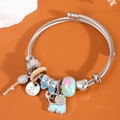 Bracciale con ciondoli a forma di elefante, chiave e cuore su fascia a spirale argento - Blu