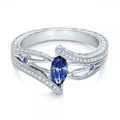 Detailed macro view of marquise-cut blue sapphire and bypass pave diamond engagement ring - US 6 / Dark Blue