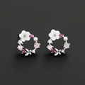 Close-up of floral hoop earrings with shell petals, pearls, and colorful zircon inlay - Silver