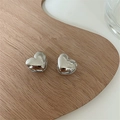 Close-up of shiny silver 3D heart-shaped stud earrings on a wooden textured tray - Medium (1.3cm) / Silver