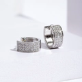 Luxury triple row pavé crystal huggie hoop earrings in polished silver metal - Silver
