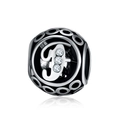Macro view of silver charm with hollow letter F design and sparkling cubic zirconia stones - Letter F