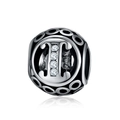 Macro detail of retro S925 silver charm bead featuring four inset cubic zirconia stones - Letter I