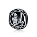Macro detail of silver charm bead with hollow patterns and letter U featuring three zircons - Letter U