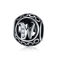 Macro view of hollow silver charm bead with letter W and sparkling zircon inlay - Letter W