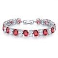 Macro detail of silver tennis bracelet with oval red and clear stones in four-prong setting - Platinum Red Zirconia (068)