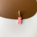 Close-up of pink gummy bear pendant with sparkling crystal-encrusted gold-plated clasp - Micropaved Pink Bear Pendant