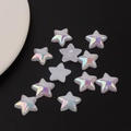Macro detail of iridescent pearl star-shaped acrylic beads for DIY crafting on black background - Medium Large