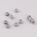 Macro shot of creamy ceramic abacus beads on a golden pin for jewelry making - Gray