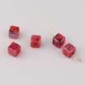 Detailed macro view of square red ceramic beads with black speckled pattern for DIY jewelry - Red and Black