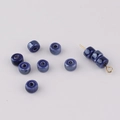 Macro shot of blue kiln-glazed ceramic beads for DIY necklace and bracelet crafting - Sapphire Blue