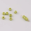 Close-up of grass green glazed ceramic spacer beads for DIY jewelry making and crafts - Yellow-Green