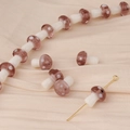 Macro detail of handmade mushroom glass beads with white dots for DIY jewelry making - Coffee Pink