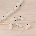 Detailed macro view of handmade white glass mushroom beads for DIY jewelry crafting - White