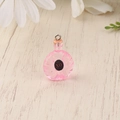 Detailed macro view of a pink resin mini XO bottle charm for DIY jewelry and crafts - Pink