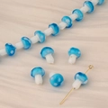 Detailed view of blue and white polka dot glass mushroom beads with gold metal pins - Sky Blue