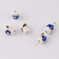Macro detail of cylindrical white ceramic beads with blue floral patterns for DIY jewelry - Blue And White Porcelain Style (6#)