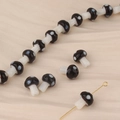 Detail of small mushroom glass beads for DIY jewelry with black polka dot design - Black