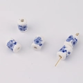 Macro detail of cylindrical blue and white floral ceramic beads for DIY jewelry making - Classic Blue Plum Style (14#)