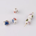 Detailed view of floral cylinder ceramic beads for DIY jewelry making and red cord bracelets - Hand-painted Colorful Floral Style (11#)