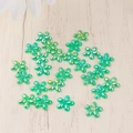 Flat lay of AB iridescent green resin flower charms for nail art and DIY crafts - Green
