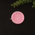 Close-up of pink round resin charm with woven basket texture and gold metal ring - Round Pink