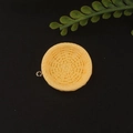 Macro detail of yellow resin woven texture pendant with silver ring for DIY jewelry making - Round Yellow