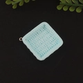 Macro detail of a light blue square resin woven basket charm with a gold loop for DIY jewelry - Blue Square