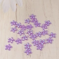 Macro shot of purple resin flower beads with AB iridescent coating for DIY nail art - Purple