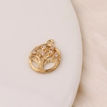 Detailed view of a gold-plated tree of life charm with sparkling cubic zirconia stones - White Tree of Life