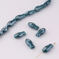 Detail of dark cyan glazed fish beads with shiny finish for DIY jewelry making and crafts - Teal