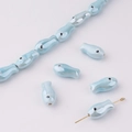 Detailed macro view of light blue fish ceramic beads with lustrous pearl glaze for DIY jewelry - Light Blue