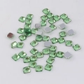 Detailed macro view of 4mm square green faceted flatback acrylic rhinestones for DIY - Light Green