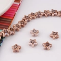 Macro shot of warm brown star-shaped ceramic beads with black smiley faces for DIY jewelry - Warm Coffee