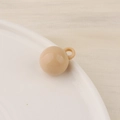 Detailed macro view of a nude candy-colored resin bead with a small loop for DIY jewelry - Small / Khaki