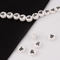 Detailed macro shot of white ceramic Leo zodiac beads for DIY bracelet jewelry making - Leo