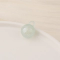 Macro shot of a translucent light green ball pendant with integrated loop on ceramic - Small / Light Green
