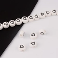 Detailed view of white ceramic Libra zodiac beads for DIY handmade jewelry crafting - Libra
