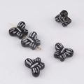 Macro detail of butterfly ceramic beads with white stripes for DIY jewelry making - Size 9