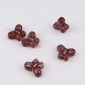 Close-up of brown butterfly ceramic beads with white stripes for DIY jewelry making - Size 7