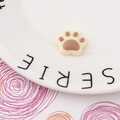 Macro detail of a resin cat paw charm for DIY phone cases on a decorative white plate - Dark Brown Style (3#)