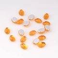 Macro detail of 4x6mm amber oval acrylic flatback rhinestones for DIY jewelry making crafts - 4x6 / Amber
