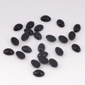 Flat lay of 4x6mm black oval acrylic flatback gems for DIY jewelry and crafts - 4x6 / Black
