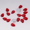 Macro detail of red acrylic teardrop flatback gems for DIY jewelry and hair accessories - 7x10mm / Red