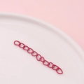 Detail view of pink painted metal extension chain with matte oval links on white tray - Rose Red (11#)