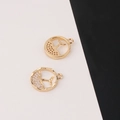 Detail of gold-plated fish tail pendants with micro-pave cubic zirconia and relief texture - Round Whale Tail Style